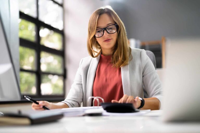 Hospital finance professional reviewing payment and reconciliation records at a desk